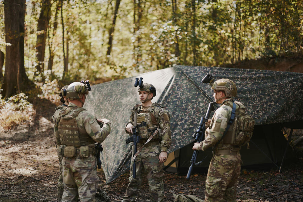 Two field operators walking through autumn woodland