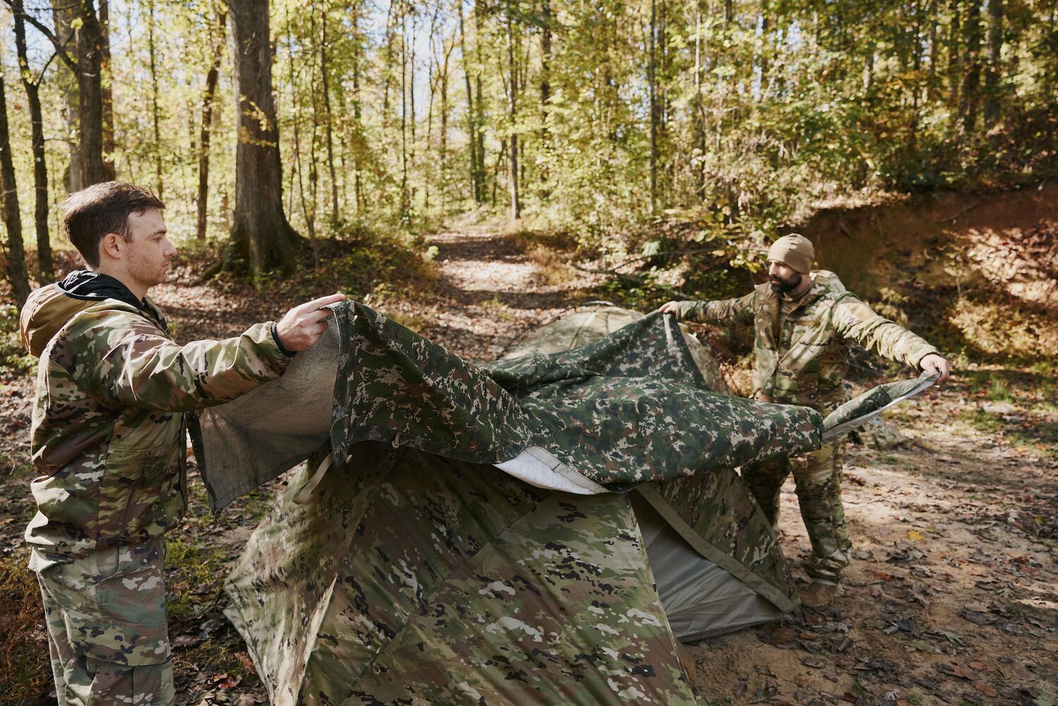 Two field operators walking through autumn woodland