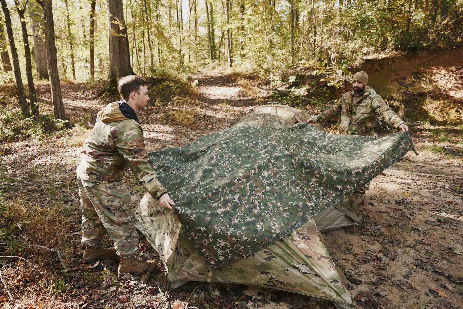 Two field operators walking through autumn woodland