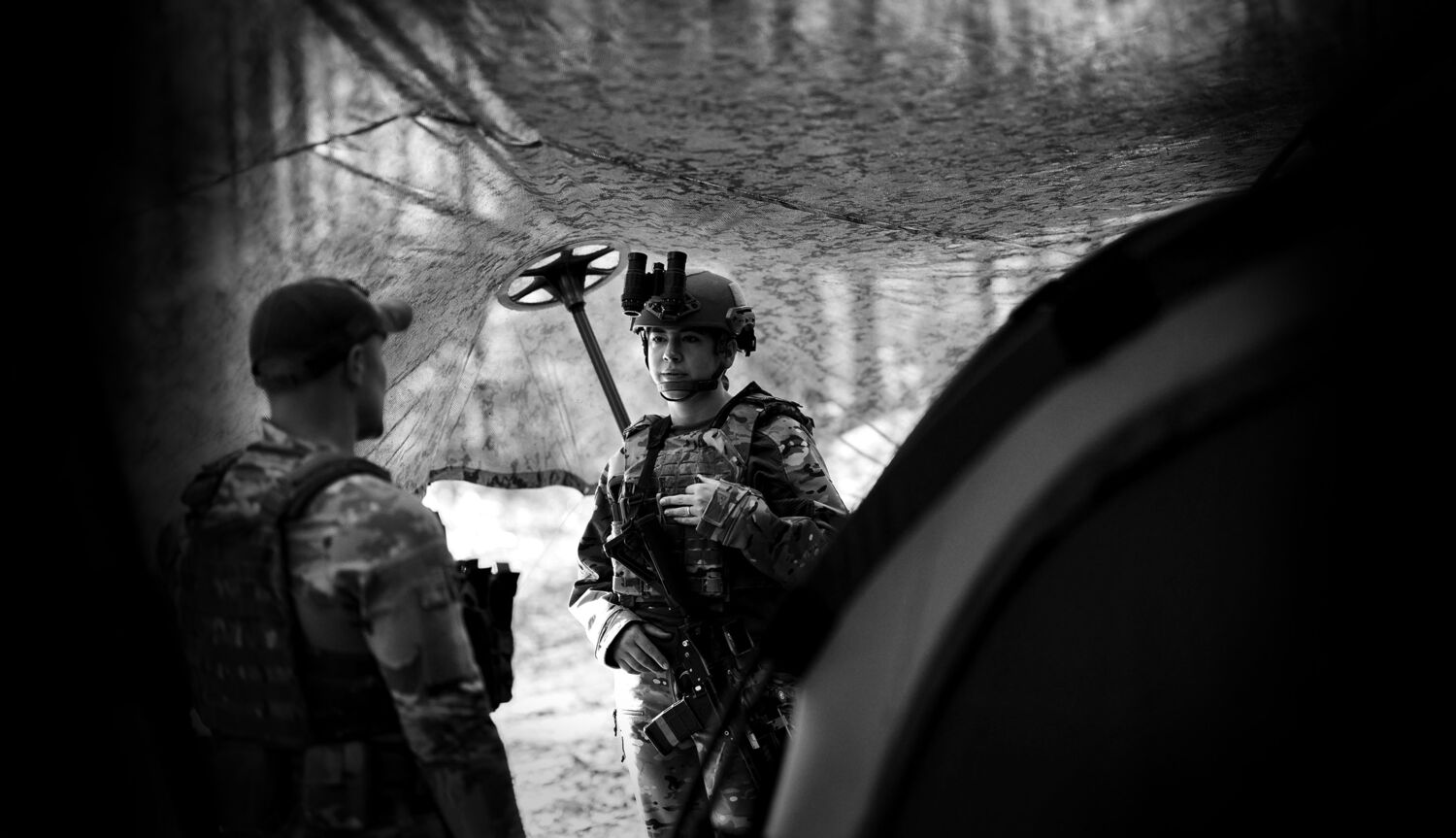 Two field operators walking through autumn woodland